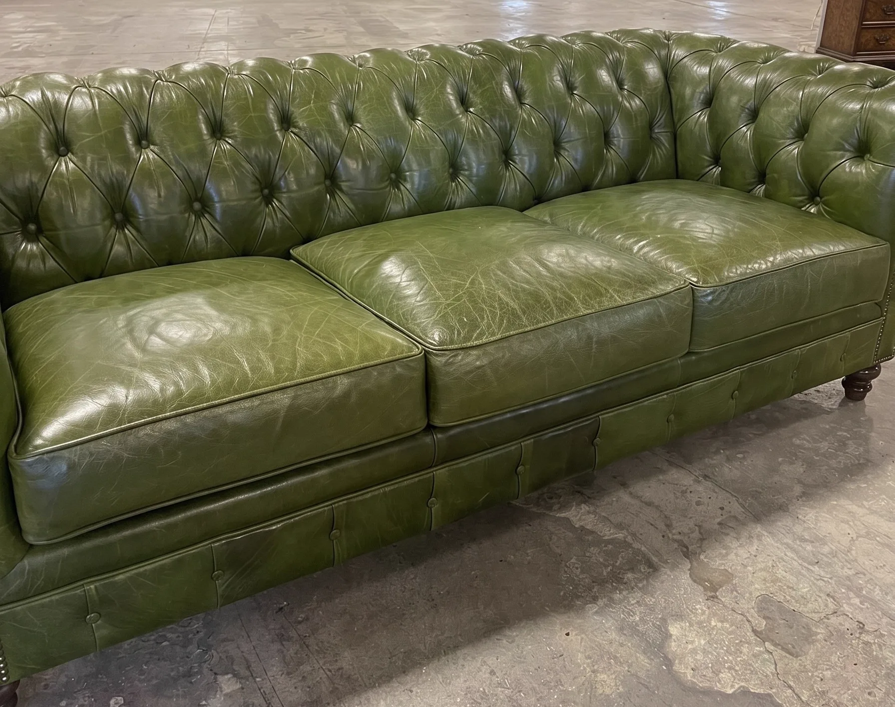 Faded, dry dark-brown leather sofa before restoration